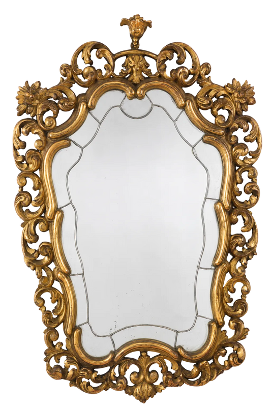 Ornate gold-coloured wall mirror with a scrolling floral openwork frame on black.