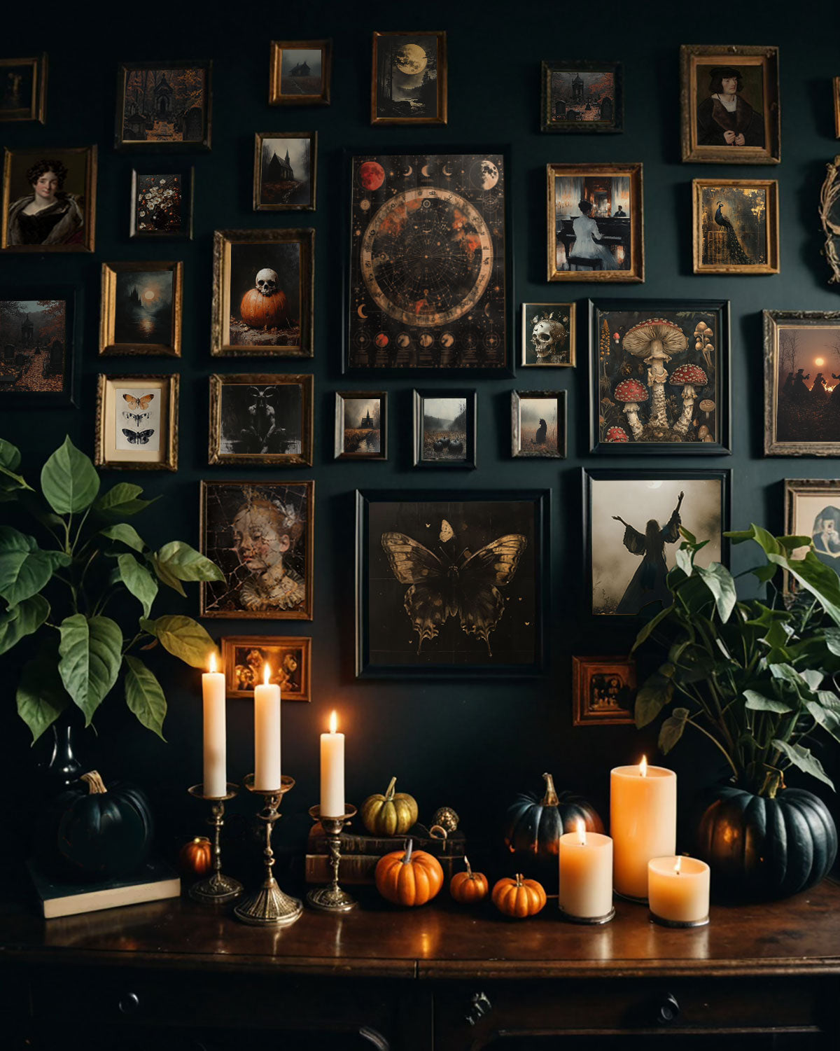 A dark, moody Halloween display with pumpkins, candles, and botanical elements arranged on a wooden table against a gallery wall.